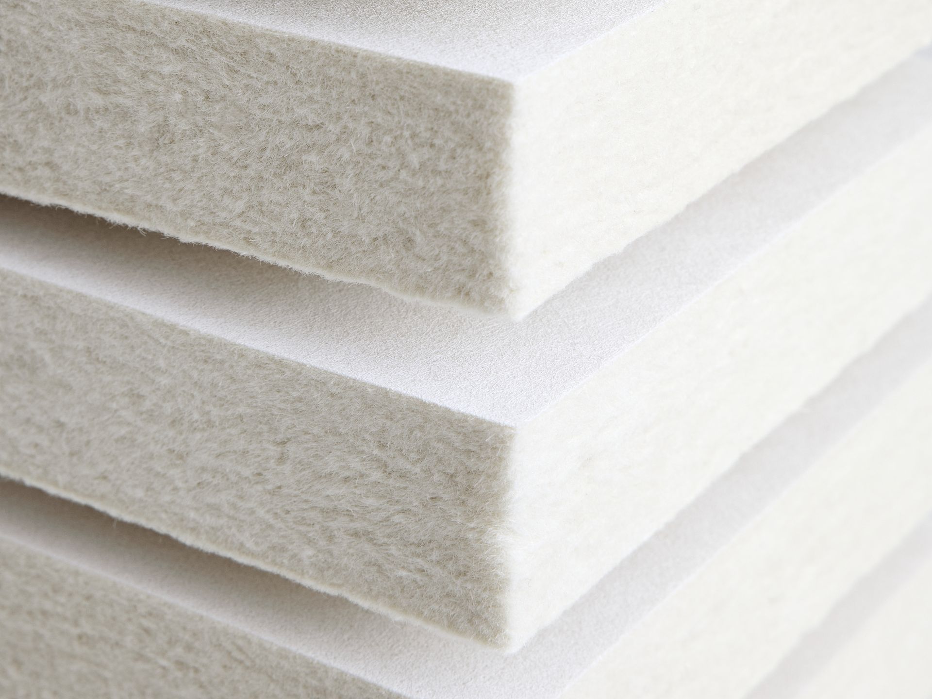 Macro of foam-formed wood fibre tile edges in raked light